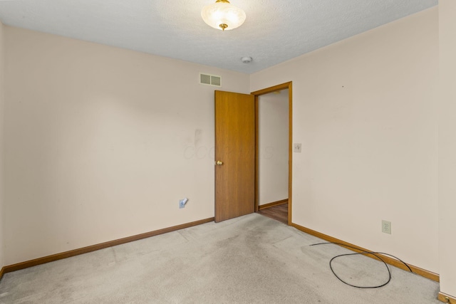 8544 Cadence Dr, Galloway, OH 43119 - empty room with light carpet, a smoke detector, and a textured ceiling