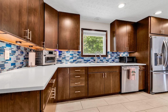 13283 Clover Valley Rd, Croton, OH 43013 - kitchen with stainless steel appliances, light countertops, backsplash, a textured ceiling, and recessed lighting