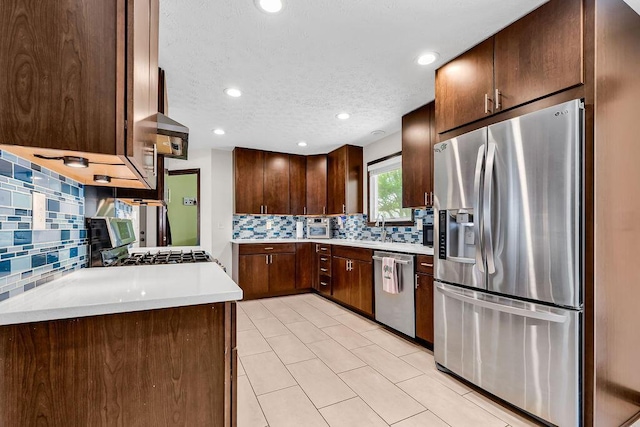 13283 Clover Valley Rd, Croton, OH 43013 - kitchen featuring stainless steel appliances, tasteful backsplash, light countertops, dark brown cabinets, and recessed lighting