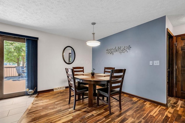 13283 Clover Valley Rd, Croton, OH 43013 - dining area featuring wood finished floors and a textured ceiling