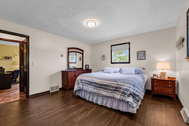 13283 Clover Valley Rd, Croton, OH 43013 - bedroom featuring dark wood-style flooring, a textured ceiling, and a desk