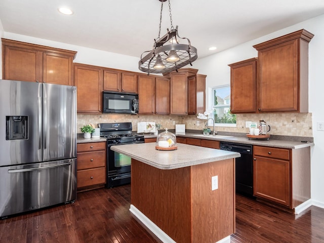 1719 Impatiens Way, Lewis Center, OH 43035 - kitchen featuring black appliances, dark wood-style flooring, brown cabinets, a kitchen island, and recessed lighting
