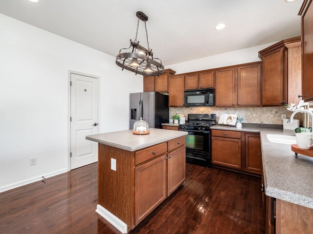 1719 Impatiens Way, Lewis Center, OH 43035 - kitchen with black appliances, decorative backsplash, dark wood finished floors, a center island, and light countertops