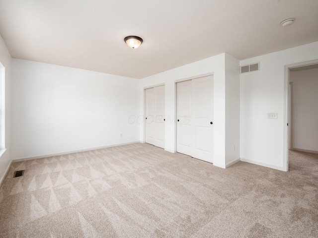 1719 Impatiens Way, Lewis Center, OH 43035 - unfurnished bedroom featuring multiple closets and carpet floors