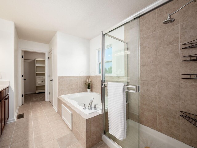 1719 Impatiens Way, Lewis Center, OH 43035 - full bath featuring vanity, a stall shower, a garden tub, a spacious closet, and tile patterned floors