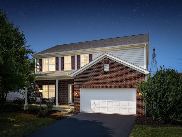 1719 Impatiens Way, Lewis Center, OH 43035 - traditional home featuring asphalt driveway, brick siding, and covered porch
