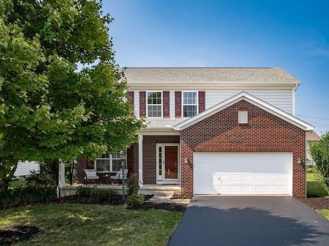 1719 Impatiens Way, Lewis Center, OH 43035 - view of front of house with asphalt driveway, brick siding, a front lawn, and an attached garage