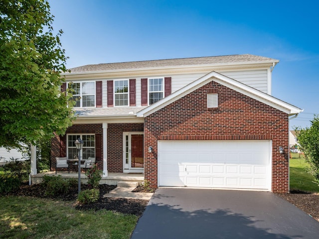 1719 Impatiens Way, Lewis Center, OH 43035 - traditional-style home featuring driveway, covered porch, brick siding, and a garage