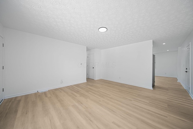 1874 Fleming Rd, Columbus, OH 43232 - additional living space featuring light wood-type flooring and a textured ceiling