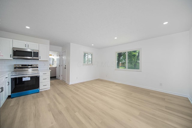 1874 Fleming Rd, Columbus, OH 43232 - kitchen with stainless steel appliances, light countertops, white cabinetry, light wood-style flooring, and recessed lighting