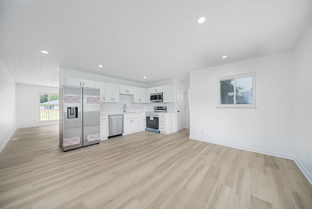 1874 Fleming Rd, Columbus, OH 43232 - kitchen with appliances with stainless steel finishes, light countertops, light wood finished floors, white cabinets, and recessed lighting