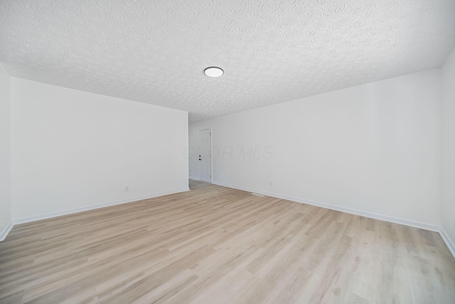 1874 Fleming Rd, Columbus, OH 43232 - additional living space featuring light wood-style floors and a textured ceiling