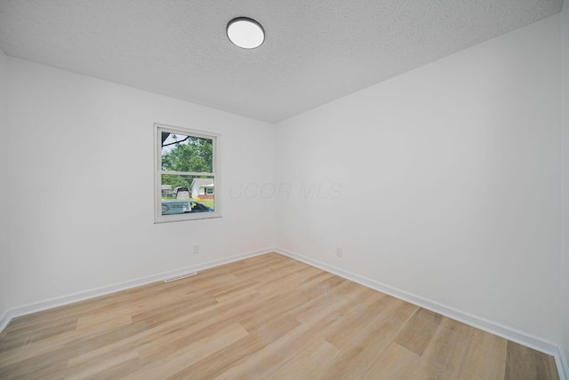 1874 Fleming Rd, Columbus, OH 43232 - unfurnished room featuring light wood finished floors and a textured ceiling