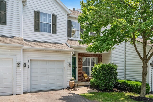 3956 Darby Park Rd, Hilliard, OH 43026 - view of front of house with a garage, a shingled roof, and driveway