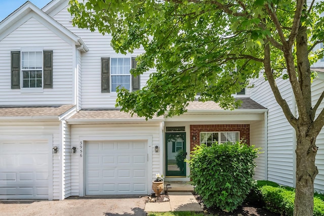 3956 Darby Park Rd, Hilliard, OH 43026 - townhome / multi-family property featuring a shingled roof, a garage, and driveway