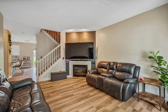 3956 Darby Park Rd, Hilliard, OH 43026 - living area featuring stairs, light wood-style flooring, and a fireplace