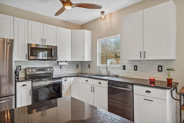 3956 Darby Park Rd, Hilliard, OH 43026 - kitchen featuring stainless steel appliances, white cabinets, ceiling fan, and decorative backsplash
