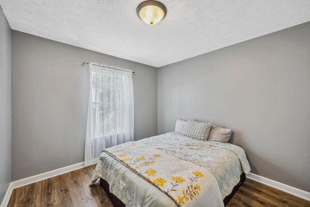3956 Darby Park Rd, Hilliard, OH 43026 - bedroom with wood finished floors and a textured ceiling