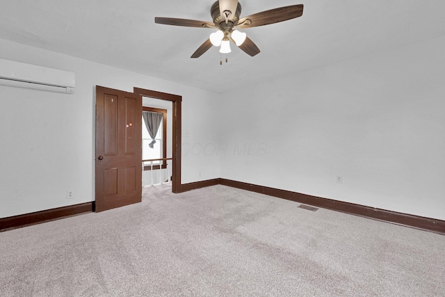 115 E Main St, Mount Sterling, OH 43143 - unfurnished room featuring an AC wall unit, carpet floors, and a ceiling fan