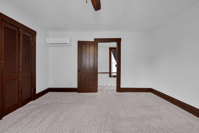 115 E Main St, Mount Sterling, OH 43143 - unfurnished bedroom with a wall unit AC, carpet, a closet, and a ceiling fan