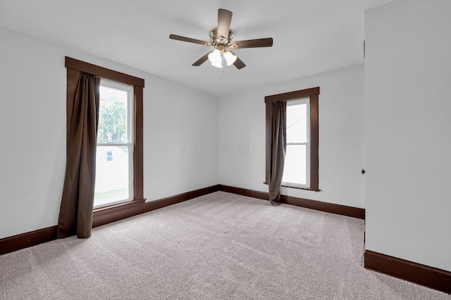 115 E Main St, Mount Sterling, OH 43143 - empty room with healthy amount of natural light, carpet, and a ceiling fan