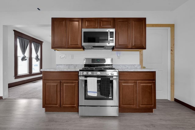 115 E Main St, Mount Sterling, OH 43143 - kitchen with stainless steel appliances, light countertops, and light wood-style flooring