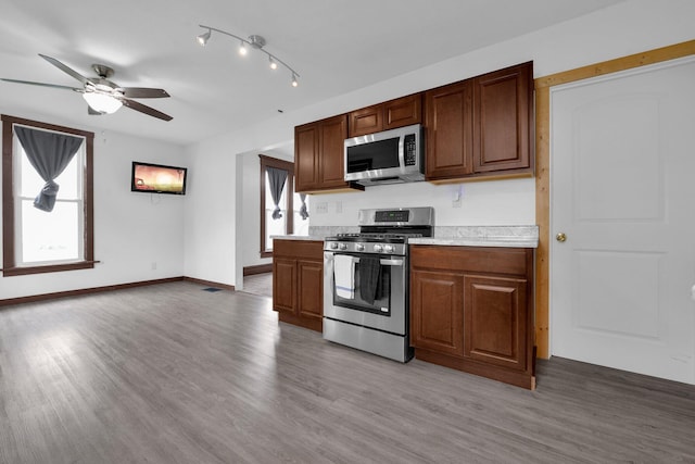 115 E Main St, Mount Sterling, OH 43143 - kitchen featuring appliances with stainless steel finishes, healthy amount of natural light, a ceiling fan, and light countertops