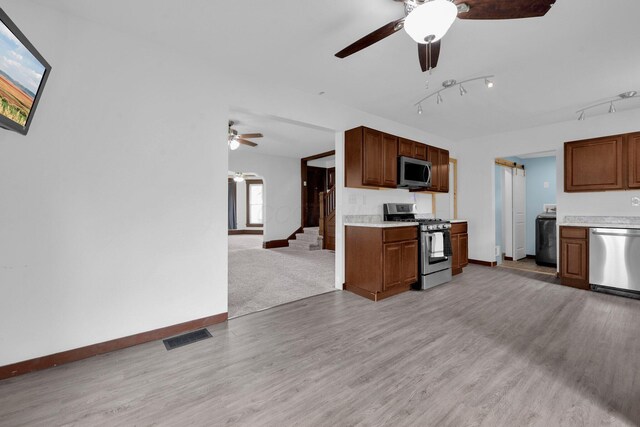 115 E Main St, Mount Sterling, OH 43143 - kitchen with appliances with stainless steel finishes, a ceiling fan, light countertops, open floor plan, and light wood-style floors