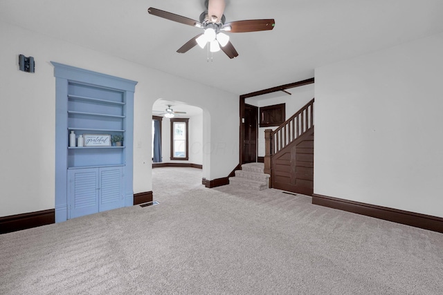 115 E Main St, Mount Sterling, OH 43143 - unfurnished living room with ceiling fan, carpet floors, stairway, and arched walkways