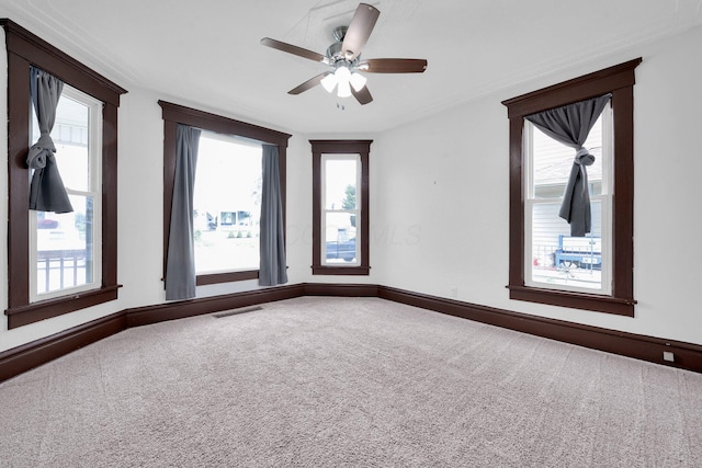 115 E Main St, Mount Sterling, OH 43143 - carpeted empty room with ceiling fan, healthy amount of natural light, and ornamental molding