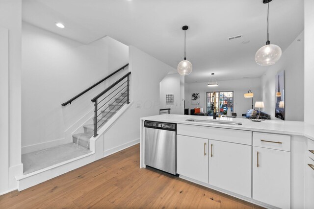 91 W Town St, Columbus, OH 43215 - kitchen featuring stainless steel dishwasher, light wood-type flooring, white cabinets, decorative light fixtures, and recessed lighting
