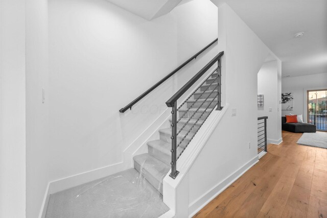 91 W Town St, Columbus, OH 43215 - stairs featuring baseboards and hardwood / wood-style floors