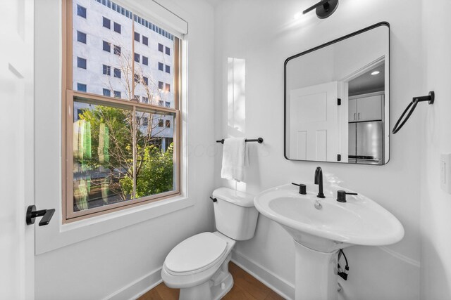 91 W Town St, Columbus, OH 43215 - half bathroom featuring baseboards and wood finished floors