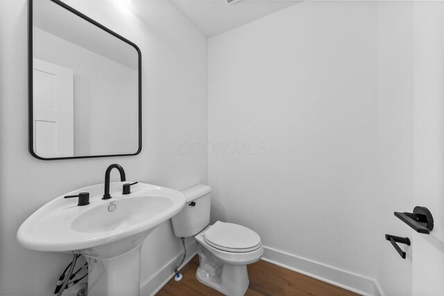 91 W Town St, Columbus, OH 43215 - half bathroom featuring wood finished floors and baseboards