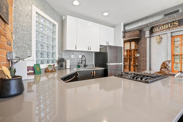 974 N High St Unit B, Columbus, OH 43201 - kitchen with freestanding refrigerator, gas cooktop, light countertops, white cabinets, and backsplash