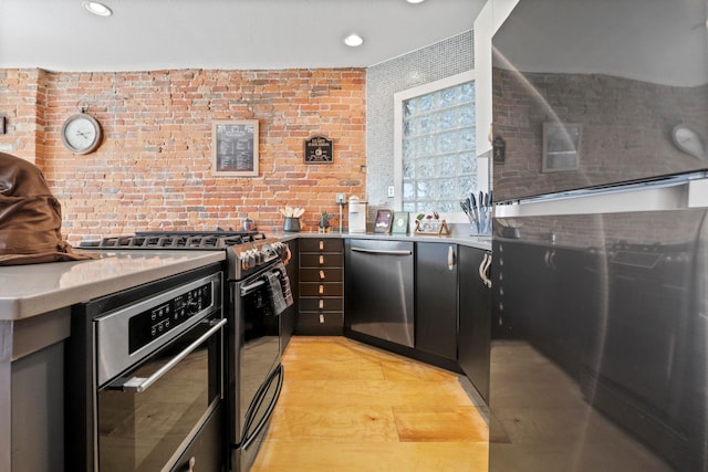 974 N High St Unit B, Columbus, OH 43201 - kitchen with stainless steel appliances, light countertops, recessed lighting, and dark cabinetry