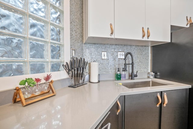974 N High St Unit B, Columbus, OH 43201 - kitchen featuring white cabinetry, tasteful backsplash, and light countertops