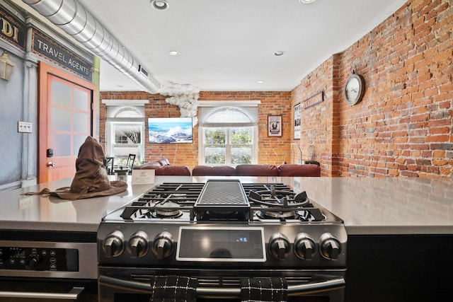 974 N High St Unit B, Columbus, OH 43201 - kitchen with black gas range oven, brick wall, oven, and recessed lighting