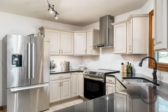 7949 Bluefield St NW, Canal Winchester, OH 43110 - kitchen featuring stainless steel appliances, wall chimney range hood, dark stone countertops, decorative backsplash, and light tile patterned floors