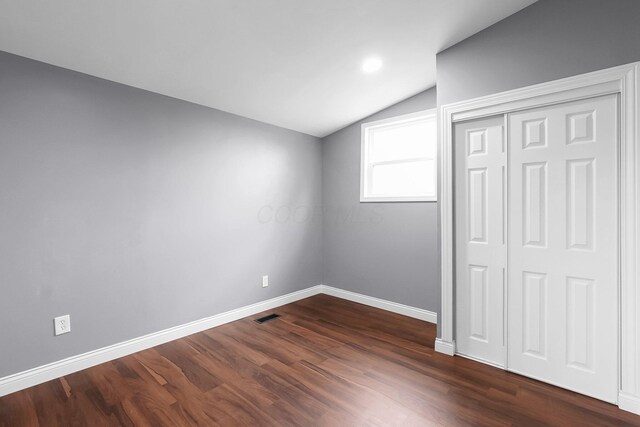 172 Jefferson St, Mount Sterling, OH 43143 - unfurnished bedroom featuring vaulted ceiling, dark wood-style flooring, and a closet