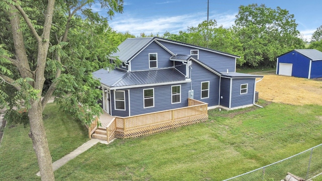 172 Jefferson St, Mount Sterling, OH 43143 - rear view of house featuring a yard, a garage, a metal roof, and an outdoor structure
