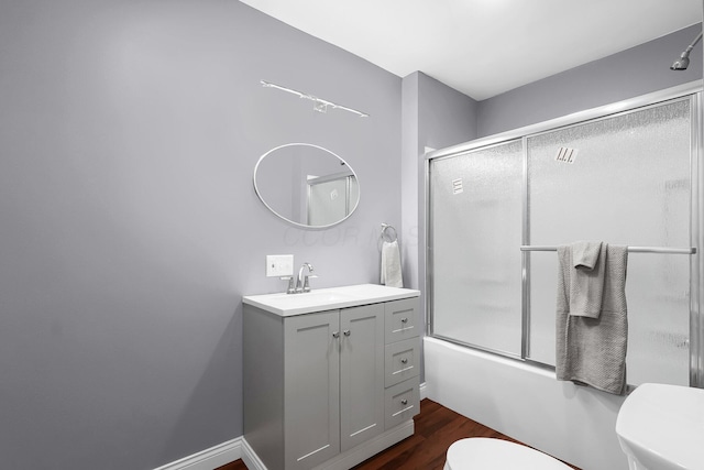 172 Jefferson St, Mount Sterling, OH 43143 - bathroom with vanity, wood finished floors, and bath / shower combo with glass door