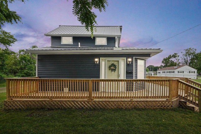 172 Jefferson St, Mount Sterling, OH 43143 - view of front of house featuring a wooden deck, a lawn, and a metal roof