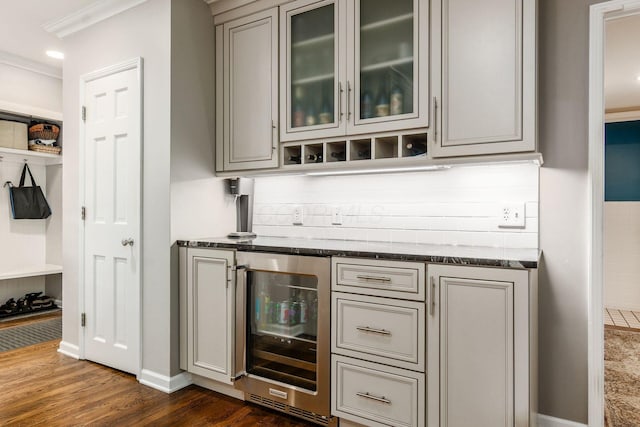 207 Ashbourne Rd, Bexley, OH 43209 - bar area featuring beverage cooler, dark wood-type flooring, crown molding, and decorative backsplash