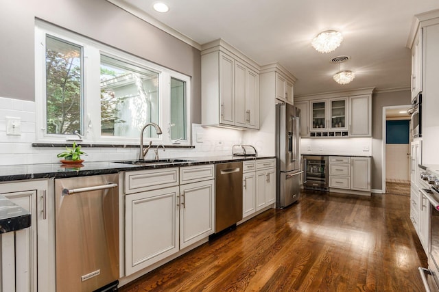 207 Ashbourne Rd, Bexley, OH 43209 - kitchen featuring beverage cooler, stainless steel appliances, dark wood-type flooring, tasteful backsplash, and ornamental molding
