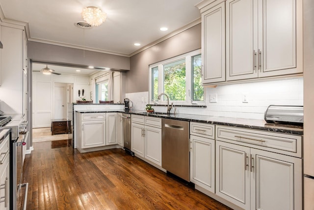 207 Ashbourne Rd, Bexley, OH 43209 - kitchen featuring stainless steel appliances, dark wood finished floors, a peninsula, tasteful backsplash, and dark stone counters