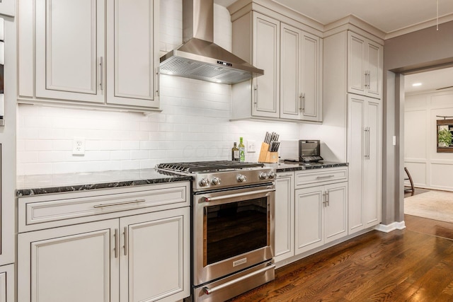 207 Ashbourne Rd, Bexley, OH 43209 - kitchen featuring wall chimney exhaust hood, high end stove, dark wood-type flooring, backsplash, and dark stone countertops