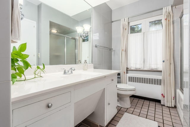 207 Ashbourne Rd, Bexley, OH 43209 - full bathroom featuring radiator heating unit, vanity, a chandelier, tile patterned flooring, and shower / bath combination with glass door