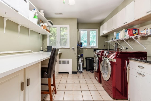 207 Ashbourne Rd, Bexley, OH 43209 - laundry area featuring radiator heating unit, independent washer and dryer, cabinet space, and light tile patterned floors