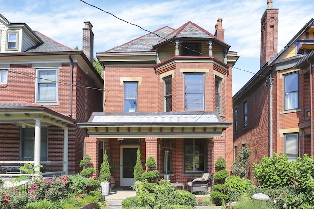 701 Dennison Ave, Columbus, OH 43215 - view of front of home with brick siding, covered porch, and a high end roof